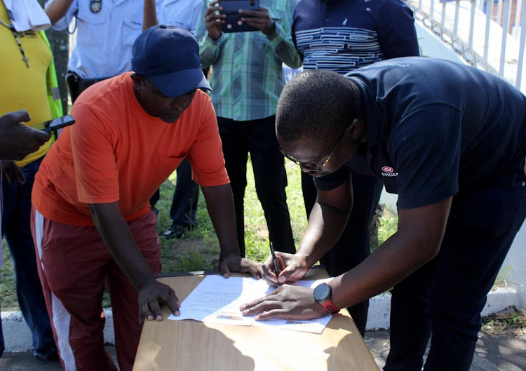 Reggie Smith for Changing Our Behaviour To Unite (COBTU) handing over the memorandum to James Nyawere, head of transformation and stakeholder engagement at Engen.