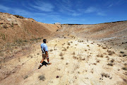 Gideon van Zyl inspects a  dry dam near his drought-hit farm  in Vredendal, Western Cape. The writer says blame shifting by the DA exposes a narrow reading on their part of the principles of co-operative governance provided in the constitution.  /Esa Alexander//Gallo Images