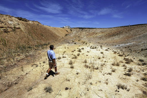 Gideon van Zyl inspects a dry dam near his drought-hit farm in Vredendal, Western Cape. The writer says blame shifting by the DA exposes a narrow reading on their part of the principles of co-operative governance provided in the constitution. /Esa Alexander//Gallo Images