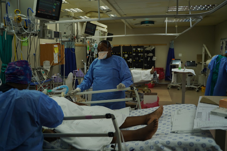 Tembisa nurses check the vital signs of a ventilated Covid positive patient, with severe acute respiratory distress syndrome (ARDS), in the hospital's Covid dedicated ICU.