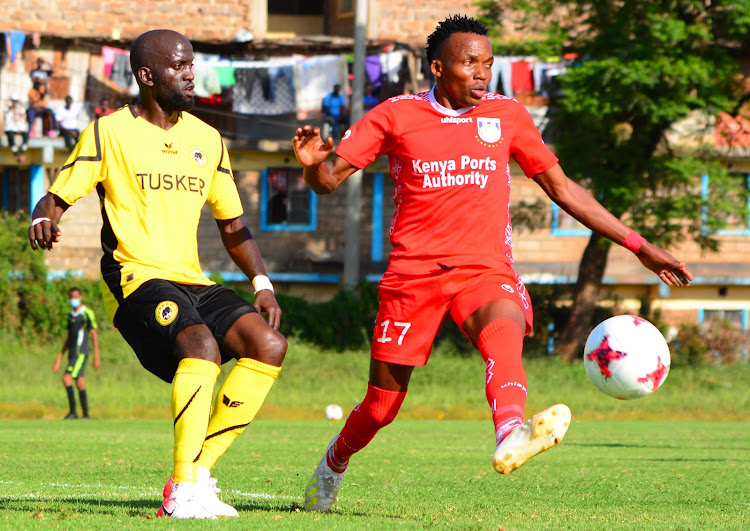 Bandari's Danson Chetambe (L) drives the ball from Kevin Okoth of Tusker during their Premier League clash at Utalii Sports Club.