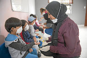 Sanitising children this week at a nursery school in Johannesburg.