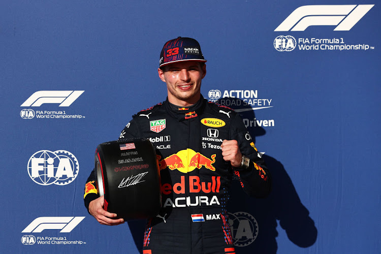 Pole position qualifier Max Verstappen celebrates in parc ferme during qualifying ahead of the F1 Grand Prix of USA at Circuit of The Americas on October 23, 2021 in Austin, Texas.