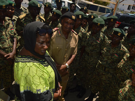 Public Service and Youth Affairs PS Lillian Mbogo-Omollo with coast regional coordinator Nelson Marwa chats with youths from the NYS at the Uhuru na Kazi premises in Mombasa. /JOHN CHESOLI