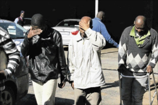 UNDER A CLOUD: Muthi murder accused Fundisile Sidumo, Monde Tokwe and Vusi Mofokeng at the Alberton Magistrate's Court. PHOTO: BAFANA MAHLANGU