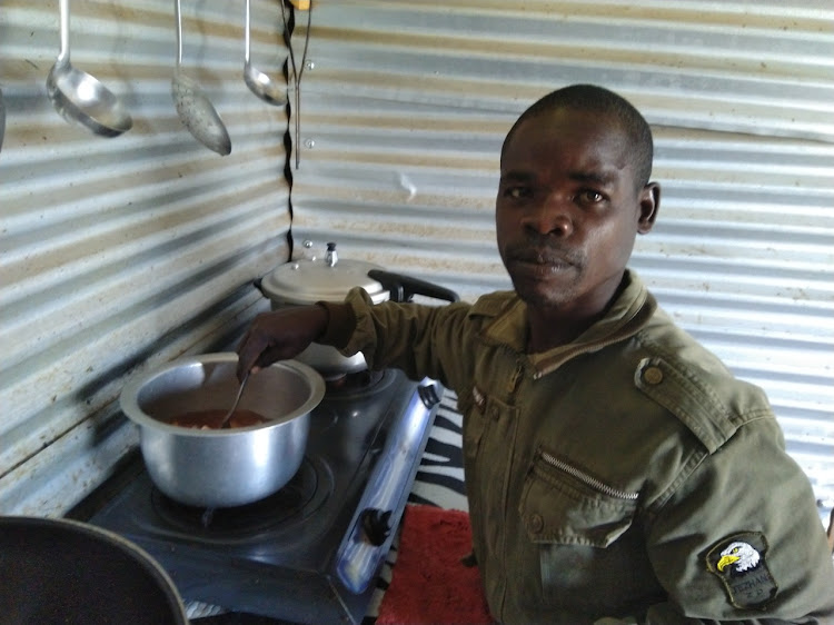 Thomas Odembo, 35, preparing a tortoise in his house on Wednesday when the Star visited him/ Manuel Odeny