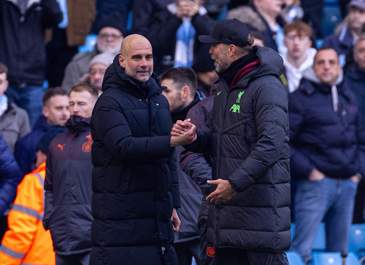 Manchester City manager Pep Guardiola (L) with Liverpool's Jurgen Klopp