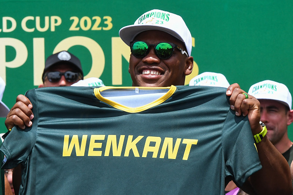 Springbok hooker Bongi Mbonambi holds a T-shirt with the word 'wenkant', which translates to 'winning side', during the Rugby World Cup tour in Cape Town.