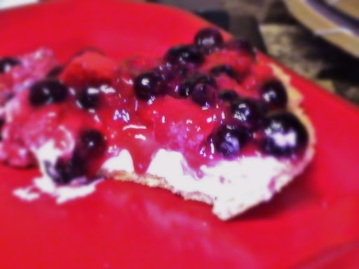 A small slice of creamy lemon flavored pie w/ blueberries in a graham crust