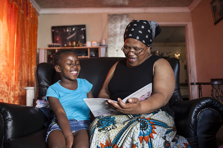 Nomfanelo Bovu reads a special story to her granddaughter, Olitha Mangcayi.