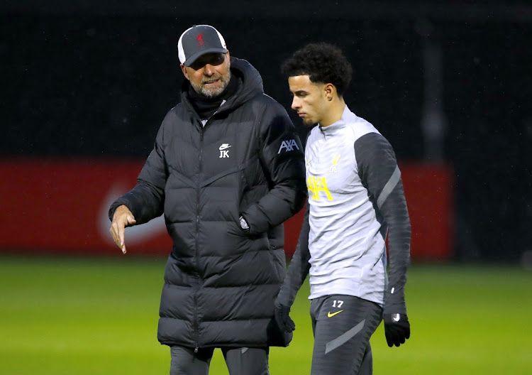 Liverpool manager Juergen Klopp talks to Curtis Jones during training.