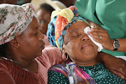 Monica Matsie and a relative at the Mahube A Tumelo Hall in Bloemfontein, where her son Katlego Bereng’s memorial service was held on May 4 2023.