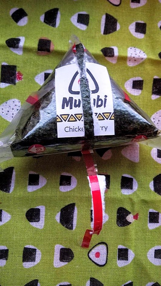 Musubi in Portland, the onigiri is carefully packaged in plastic with a red strip guiding you how to open it- and it keeps it separate so the seaweed stays crispy and dry away from the more moist rice portion until the moment of consumption and you bring it together.