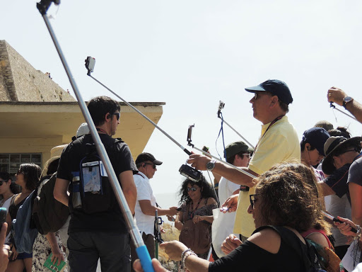 Tourists using their selfie sticks at the Acropolis in Athens, Greece. 