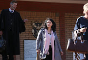 Estate agent, Vicky Momberg, leaves the Randburg Magistrates Court. She was served with a summons on crimen injuria charges for shouting insults at police.