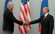 Russian Prime Minister Vladimir Putin (R) shakes hands with US Vice President Joe Biden in this  file photo 