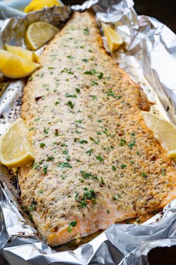 Salmon topped with butter, garlic, parmesan and lemon and baked to perfection!