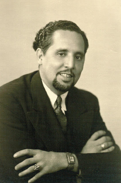 Black and white photo of Raoul Cortez smiling for a portrait.