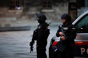 Police officers stand guard after exchanges of gunfire in Vienna, Austria November 3, 2020. 