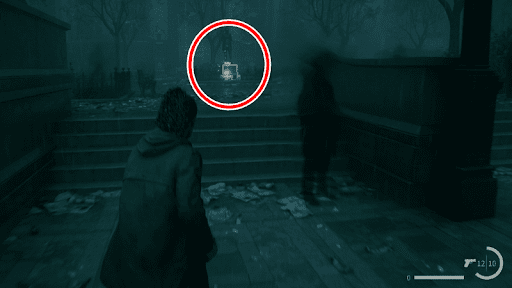 Examine the shoe box next to the statue