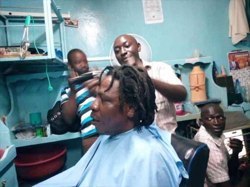 Businessman David Oguyo at a barber shop in Siaya town where he shaved off his 10-year dreadlocks, January 31, 2018../ERIC OLOO