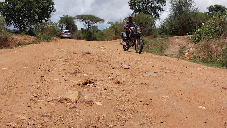 A motorist and motorcyclist plying on Wamunyu - Kalawa road in Mwala, Machakos County on April 1, 2024.