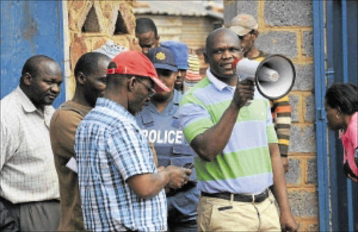 MURDERS MUST END: Councillor Vusi Mcunana addressing Driefontein residents after Saturday night's slaughter. PHOTO: TSHEKO KABASIA