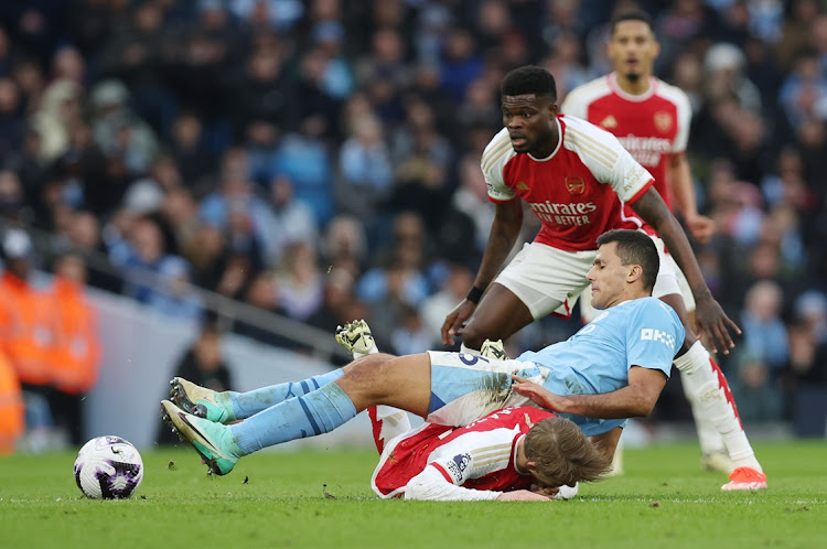 Rodri of Manchester City is challenged by Martin Odegaard of Arsenal in their Premier League match at Etihad Stadium in Manchester on Sunday.