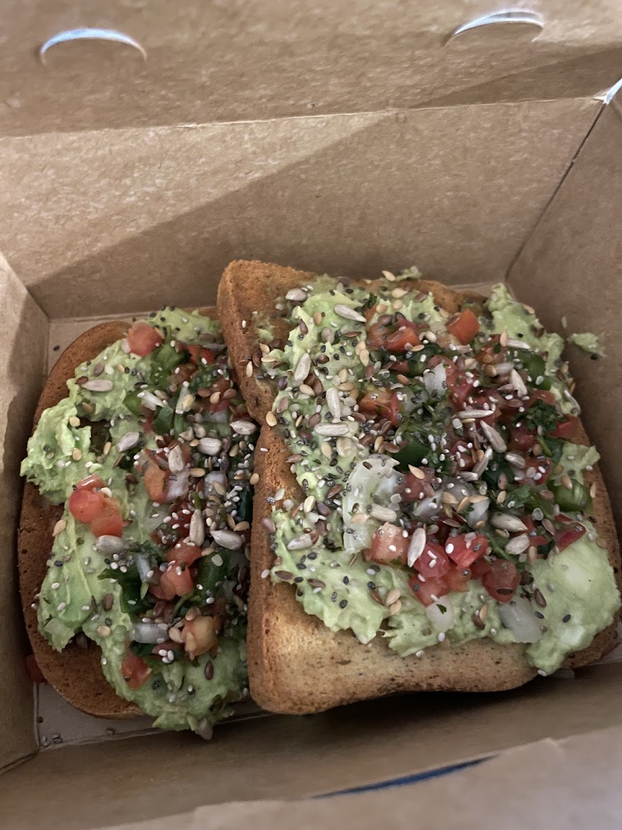 Avocado Toast on Gluten Free Bread. Avocado is topped with a pico and seed blend.