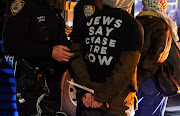 A police officer detains a protester after blocking a street during a protest demanding the US government to stop arming Israel, during the ongoing conflict between Israel and Hamas, in the Brooklyn borough of New York City, US, on April 23 2024.