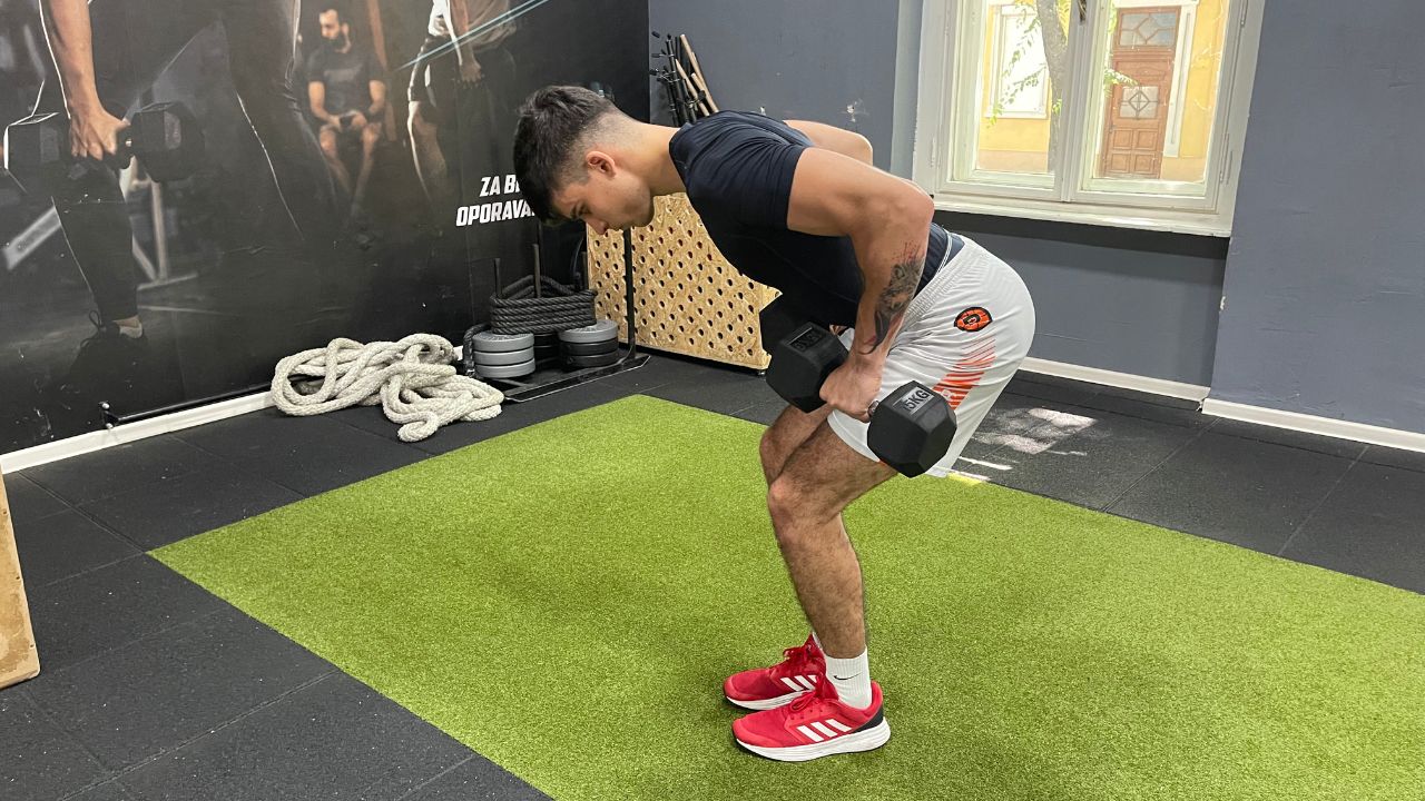 Vanja performs dumbbell bent-over rows.