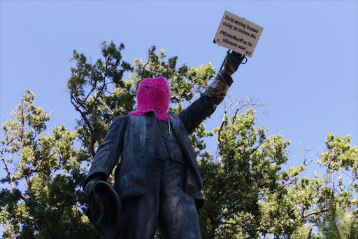 Cecil John Rhodes statue in the Company Gardens covered to highlight the plight of ex-mineworkers suffering from a lung disease called silicosis. Image: Anthony Molyneaux