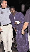 GOTCHA: FBI agents escort the Somali pirate US officials have identified as Abdiwali Abdiqadir Muse into FBI headquarters in New York on Monday. Muse is the sole surviving Somali pirate from the hostage-taking of ship captain Richard Phillips. 20/04/09. Pic. Louis Lanzano. © AP.