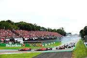 Ferrari's Kimi Raikkonen and Sebastian Vettel race to the first corner ahead of Mercedes' Lewis Hamilton during the Italian Grand Prix at Autodromo di Monza on September 2 2018 in Monza, Italy.