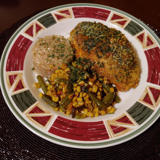 Panko encrusted stuffed chicken breast with herb butter served with risotto and pan-seared corn and green beans.