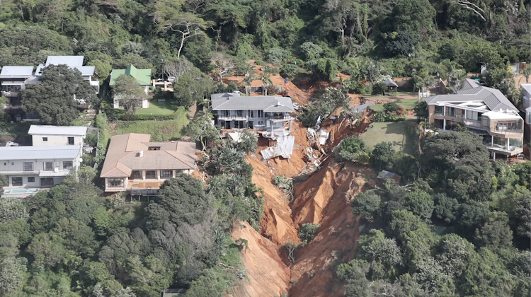 A ravine has opened beneath a house in Umdloti near Durban after heavy rains caused flooding in the city on April 12 2022.