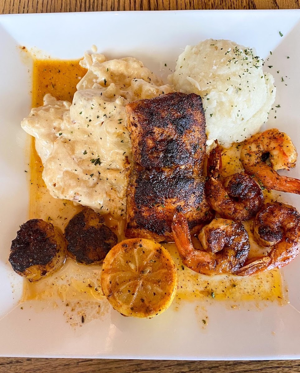 The BLVD special with blackened fish, blackened scallops, and blackened shrimp. Sides are mashed potatoes and scalloped potatoes