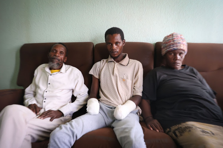 Dumisami Mahlangu, 29, with his parent Johannes Mahlangu and Emma Motsweni. His hands were chopped off with a panga after he was accused of stealing from a church in Kwa-Guqa in Emalahleni.