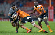 The Toyota Cheetahs' Carl Wegner (C) tackles The Crusaders' Seta Tamanivalu during the SUPERXV rugby union match between The Cheetahs and The Crusaders at the Bloemfontein rugby stadium in Bloemfontein on April 29, 2017. CHRISTIAAN KOTZE / AFP