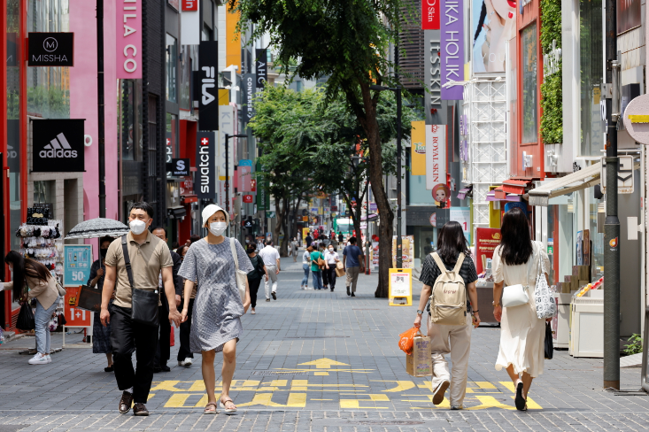 People wearing masks walk in a shopping district amid the coronavirus disease pandemic in Seoul, South Korea, on July 9, 2021.