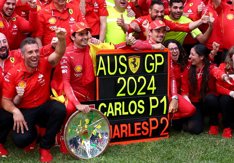 Ferrari's Carlos Sainz Jnr celebrates with his team after winning the Australian Grand Prix along with second placed Ferrari's Charles Leclerc at Melbourne Grand Prix Circuit on March 24, 2024