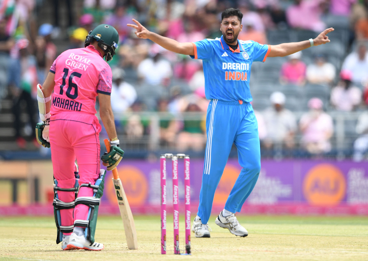 Avesh Khan (right) of India celebrates the wicket of Keshav Maharaj of the Proteas during the 1st One Day International match at Wanderers Stadium on December 17, 2023.