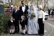 Stella Moris, partner of WikiLeaks founder Julian Assange, arrives with their sons Max, 3, and Gabriel, 4, at HMP Belmarsh prison before her wedding to Assange, in London, Britain, March 23, 2022. 