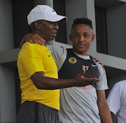 Kaizer Chiefs development coach Ace Khuse (L) chats to attacking midfielder Hendrick Ekstein (R) during the club's media day at Naturena in the south of Johannesburg on February 5 2019.  