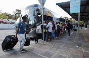 Students who have had to vacate University of Cape Town residences queue to board buses home on March 19 2020.