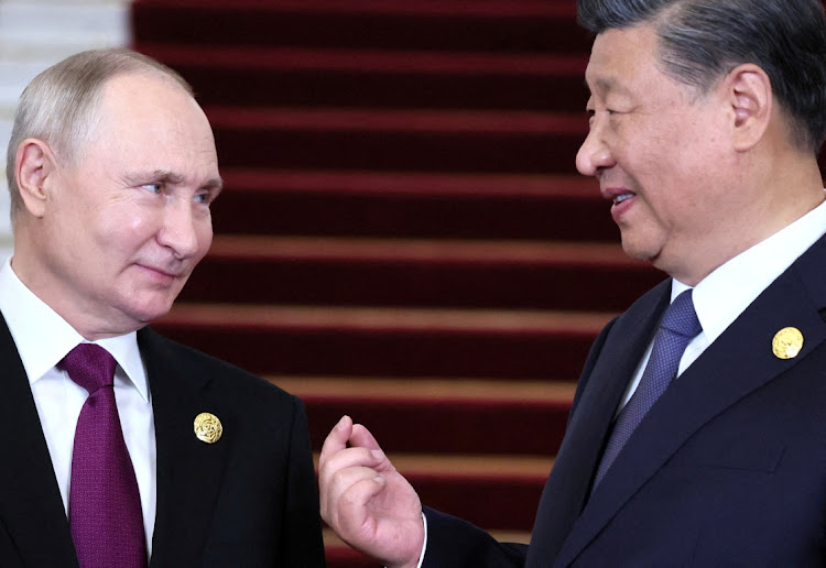 Russian President Vladimir Putin. left, speaks with Chinese President Xi Jinping in Beijing, China, in this 2023 file photo. Picture: REUTERS