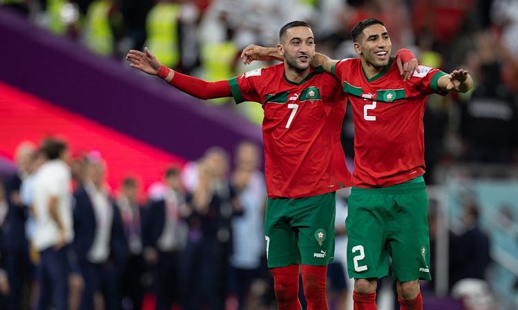 Morocco's Hakim Ziyech and Achraf Hakimi celebrate at full-time of their World Cup last-16 match win against Spain at Education City Stadium in Ar-Rayyan, Qatar on December 6 2022. Morocco meet Portugal in Saturday's quarterfinal.