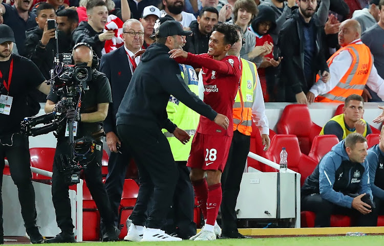 Fabio Carvalho of Liverpool celebrates scoring their last-gasp winning goal with manager Juergen Klopp in the Premier League match against Newcastle United at Anfield on August 31 2022.