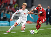 Denmark's Kasper Dolberg in action with Russia's Fyodor Kudryashov. 