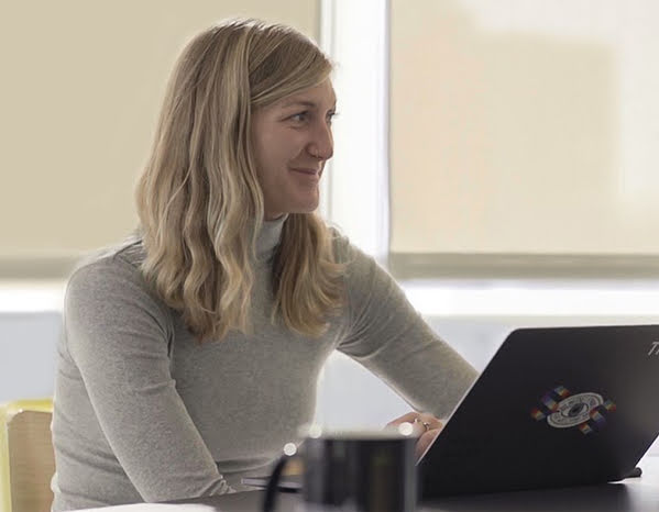 Man and woman talking in front of computer.